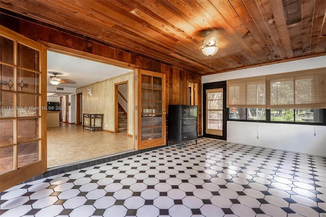 576 Marshall Rd, West Palm Beach, FL 33413 - unfurnished room featuring tile patterned floors, wood walls, wooden ceiling, stairs, and ceiling fan