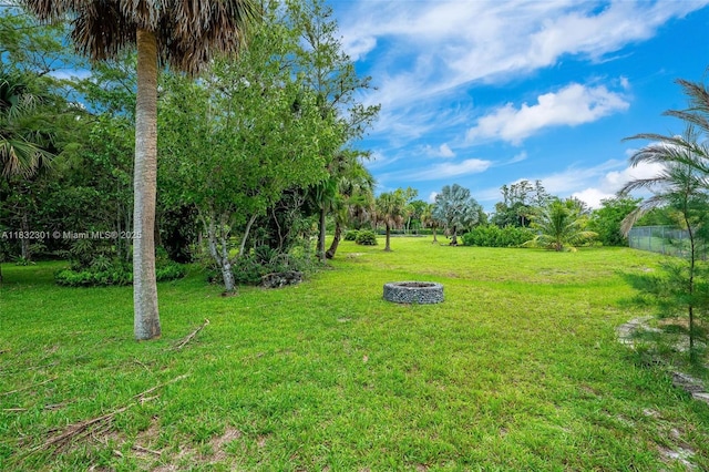 576 Marshall Rd, West Palm Beach, FL 33413 - view of green lawn featuring an outdoor fire pit