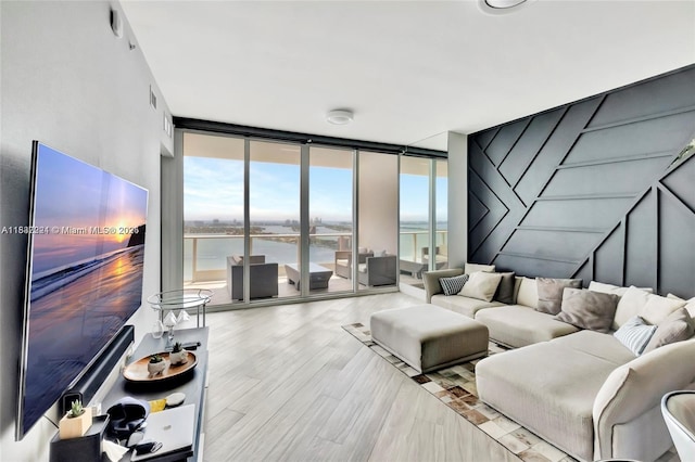 2020 N Bayshore Dr Unit 3408, Miami, FL 33137 - living area with a water view, floor to ceiling windows, healthy amount of natural light, and wood finished floors