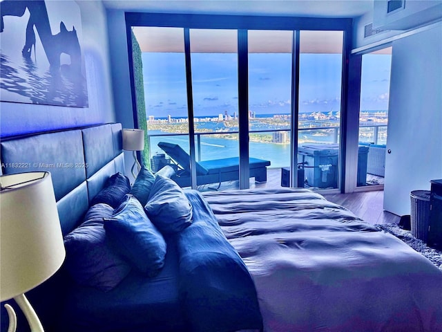 2020 N Bayshore Dr Unit 3408, Miami, FL 33137 - bedroom featuring wood finished floors and a water view