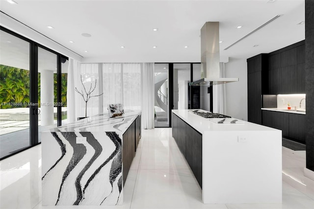 13441 Mustang Trl, Southwest Ranches, FL 33330 - kitchen featuring modern cabinets, island range hood, dark cabinets, a large island, and expansive windows