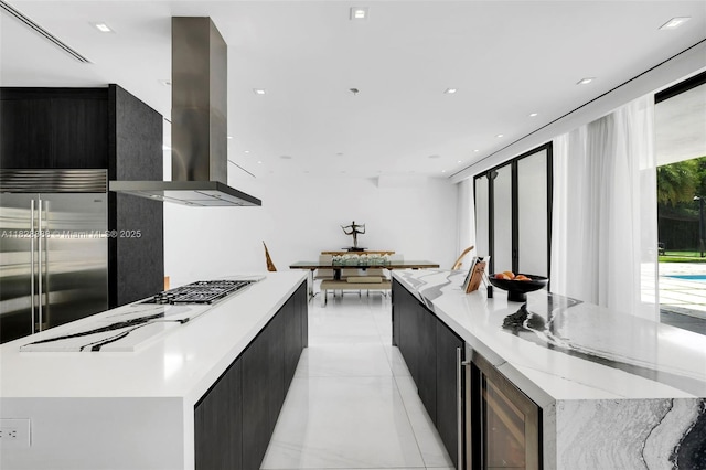 13441 Mustang Trl, Southwest Ranches, FL 33330 - kitchen with modern cabinets, ventilation hood, a spacious island, appliances with stainless steel finishes, and dark cabinets