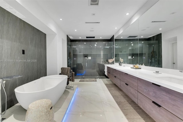 13441 Mustang Trl, Southwest Ranches, FL 33330 - bathroom with double vanity, a stall shower, a freestanding tub, marble tiled floors, and recessed lighting