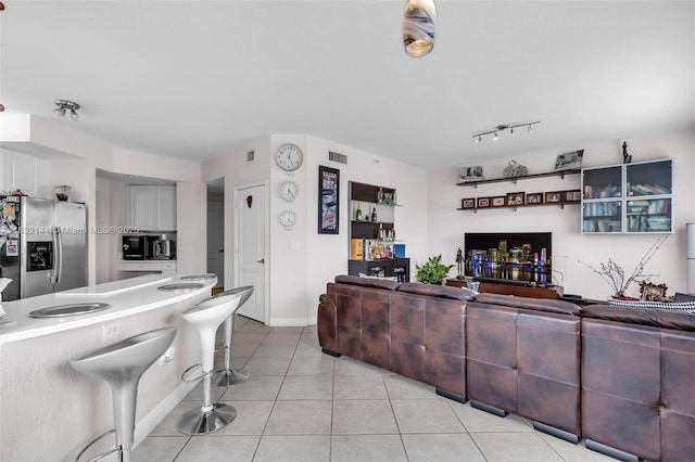 10700 NW 66th St Unit 308, Doral, FL 33178 - living area with light tile patterned flooring and baseboards