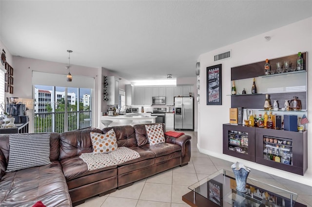 10700 NW 66th St Unit 308, Doral, FL 33178 - living area with light tile patterned flooring and a dry bar