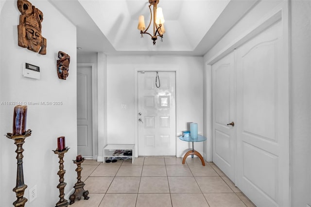 10700 NW 66th St Unit 308, Doral, FL 33178 - entryway with light tile patterned floors, a chandelier, and vaulted ceiling