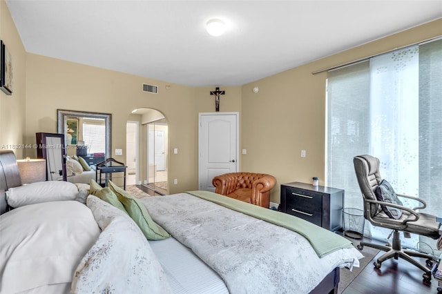 10700 NW 66th St Unit 308, Doral, FL 33178 - bedroom featuring arched walkways and wood finished floors