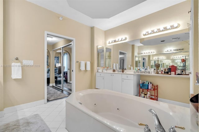 10700 NW 66th St Unit 308, Doral, FL 33178 - bathroom featuring a whirlpool tub, vanity, and tile patterned flooring
