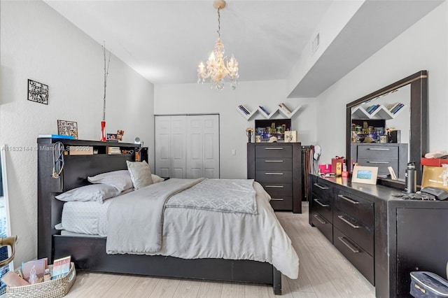 10700 NW 66th St Unit 308, Doral, FL 33178 - bedroom featuring light wood finished floors, a chandelier, and a closet