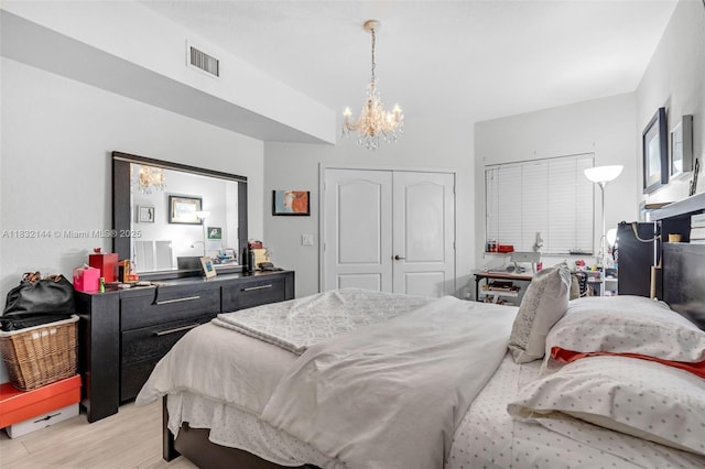 10700 NW 66th St Unit 308, Doral, FL 33178 - bedroom featuring a chandelier, light wood-style flooring, and a closet