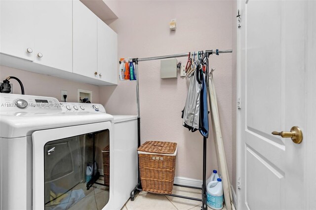10700 NW 66th St Unit 308, Doral, FL 33178 - laundry room featuring cabinet space, separate washer and dryer, and light tile patterned floors