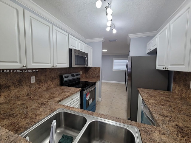 7145 NW 173rd Dr Unit 1108, Hialeah, FL 33015 - kitchen with appliances with stainless steel finishes, light tile patterned floors, white cabinetry, backsplash, and crown molding