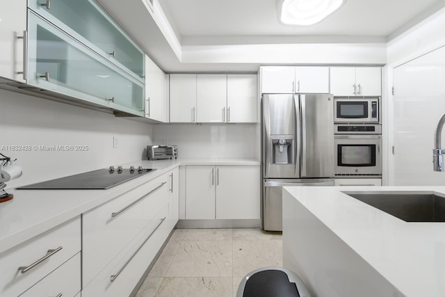 18911 Collins Ave Unit 2002, Sunny Isles Beach, FL 33160 - kitchen with appliances with stainless steel finishes, light marble finish flooring, and light countertops