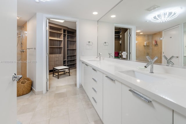 18911 Collins Ave Unit 2002, Sunny Isles Beach, FL 33160 - full bathroom with a spacious closet, a shower stall, double vanity, tile patterned flooring, and recessed lighting