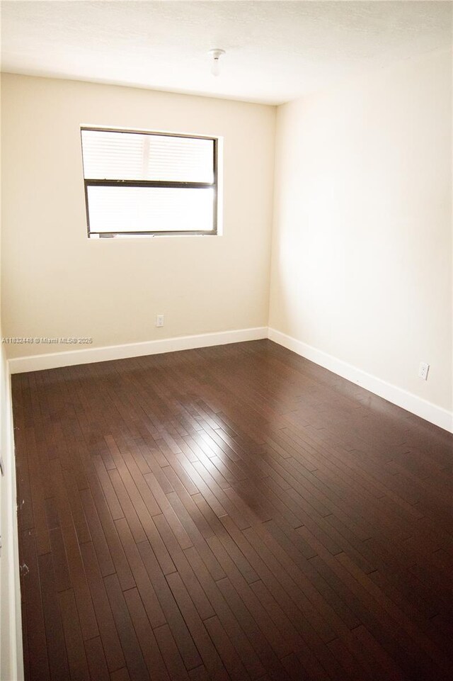 1239 NW 122nd Ter, Pembroke Pines, FL 33026 - empty room with baseboards and dark wood-style flooring