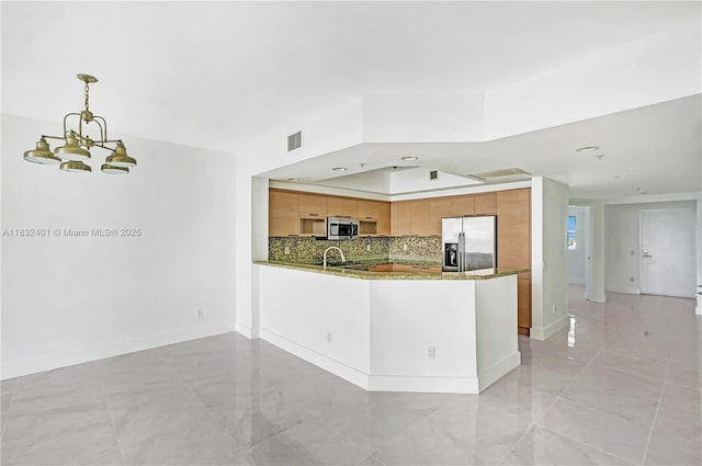 14951 Royal Oaks Ln Unit 806, North Miami, FL 33181 - kitchen with appliances with stainless steel finishes, a chandelier, a peninsula, decorative backsplash, and dark stone counters