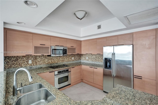 14951 Royal Oaks Ln Unit 806, North Miami, FL 33181 - kitchen featuring stainless steel appliances, a raised ceiling, light stone counters, backsplash, and light brown cabinets