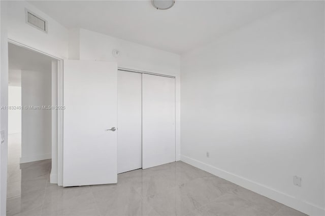 14951 Royal Oaks Ln Unit 806, North Miami, FL 33181 - unfurnished bedroom featuring baseboards and a closet