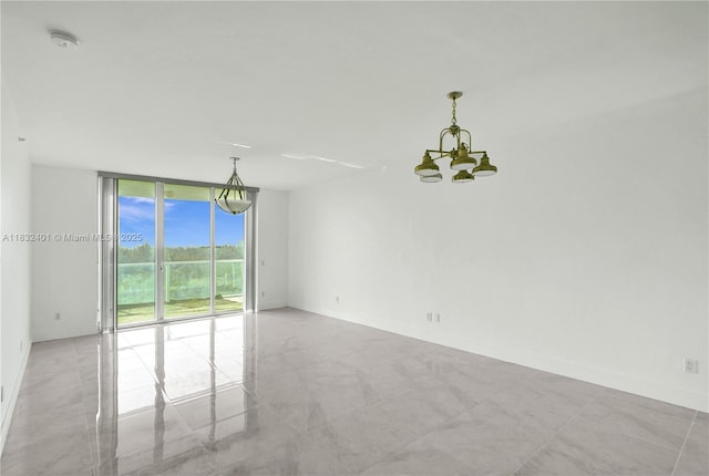 14951 Royal Oaks Ln Unit 806, North Miami, FL 33181 - unfurnished room featuring expansive windows, a smoke detector, and a chandelier