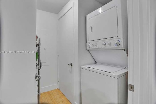 18201 Collins Ave Unit 1202, Sunny Isles Beach, FL 33160 - washroom with stacked washer / drying machine and light wood-type flooring