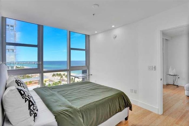 18201 Collins Ave Unit 1202, Sunny Isles Beach, FL 33160 - bedroom with a water view, light wood-style floors, floor to ceiling windows, and recessed lighting