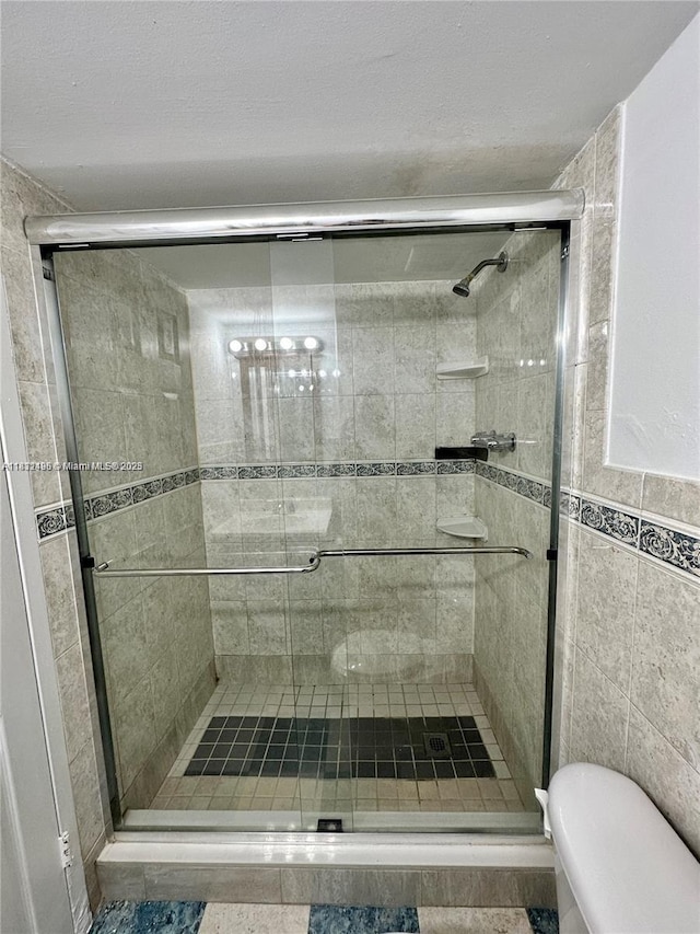 1800 Sans Souci Blvd Unit 105, North Miami, FL 33181 - bathroom with a stall shower and tile walls