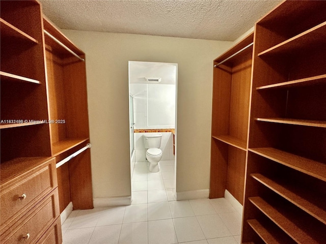 1800 Sans Souci Blvd Unit 105, North Miami, FL 33181 - walk in closet with light tile patterned floors