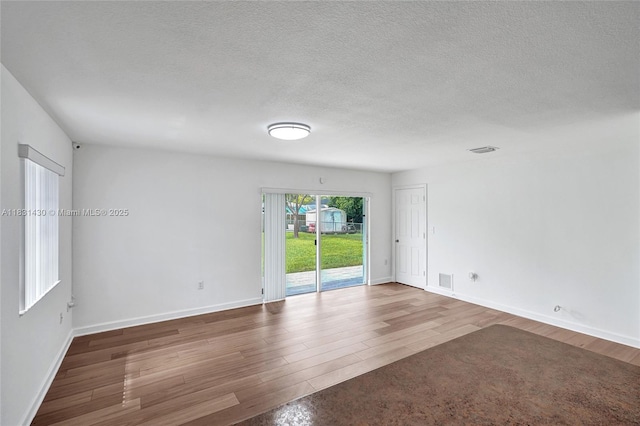 12254 SW 217th St, Miami, FL 33170 - unfurnished room featuring wood finished floors and a textured ceiling