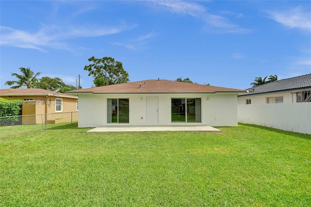 12254 SW 217th St, Miami, FL 33170 - rear view of property featuring stucco siding, a patio area, and a fenced backyard