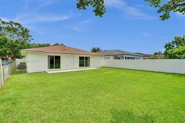12254 SW 217th St, Miami, FL 33170 - back of property with stucco siding, a fenced backyard, and a patio