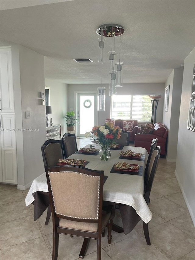 8312 NW 59th St, Tamarac, FL 33321 - dining area featuring a textured ceiling and light tile patterned floors