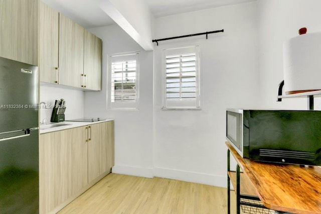 505 SE 20th St, Fort Lauderdale, FL 33316 - kitchen with freestanding refrigerator, light wood finished floors, light countertops, and modern cabinets
