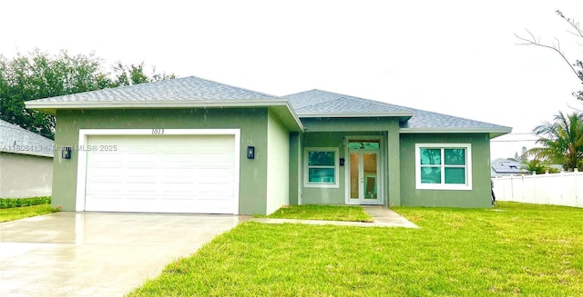 1013 SW Deauville Ave, Port St Lucie, FL 34953 - view of front of property featuring a shingled roof, stucco siding, an attached garage, and concrete driveway