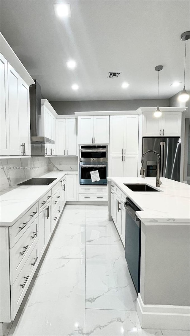 1013 SW Deauville Ave, Port St Lucie, FL 34953 - kitchen featuring wall chimney exhaust hood, appliances with stainless steel finishes, light marble finish flooring, white cabinets, and recessed lighting