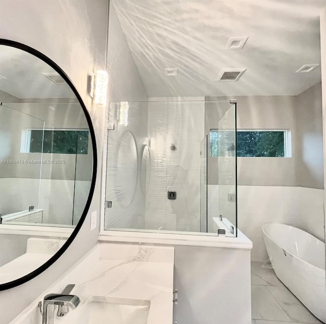 1013 SW Deauville Ave, Port St Lucie, FL 34953 - full bath with marble look tiles, a freestanding tub, a shower stall, and vanity