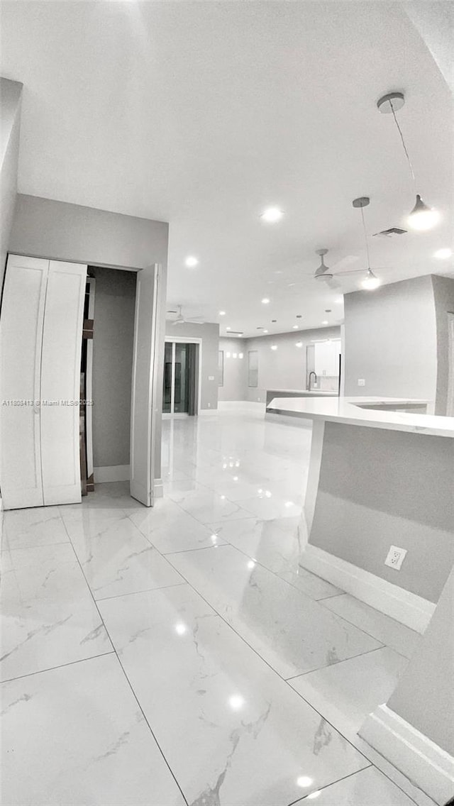 1013 SW Deauville Ave, Port St Lucie, FL 34953 - unfurnished living room with light marble finish floors, a ceiling fan, and recessed lighting