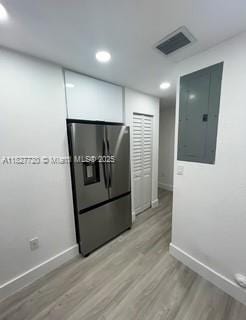 972 N 18th Ct, Hollywood, FL 33020 - kitchen with fridge with ice dispenser, electric panel, light wood-style floors, and recessed lighting