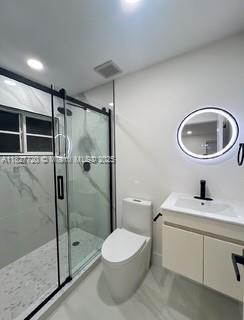 972 N 18th Ct, Hollywood, FL 33020 - bathroom featuring vanity, a shower stall, marble finish flooring, and recessed lighting