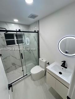 972 N 18th Ct, Hollywood, FL 33020 - bathroom with vanity, a marble finish shower, marble finish flooring, and recessed lighting