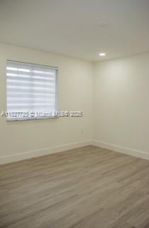972 N 18th Ct, Hollywood, FL 33020 - empty room with wood finished floors and recessed lighting
