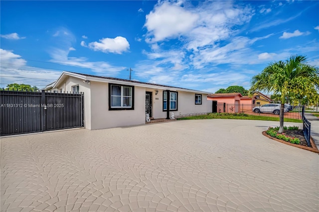 1315 W 79th St, Hialeah, FL 33014 - ranch-style house featuring stucco siding and a gate