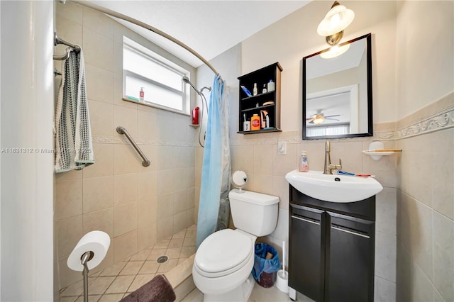 1315 W 79th St, Hialeah, FL 33014 - full bathroom featuring vanity, a tile shower, tile walls, ceiling fan, and wainscoting