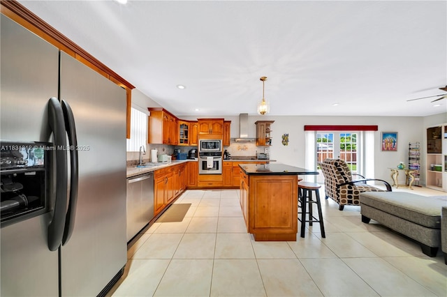 1315 W 79th St, Hialeah, FL 33014 - kitchen featuring appliances with stainless steel finishes, wall chimney range hood, a breakfast bar, glass insert cabinets, and brown cabinetry