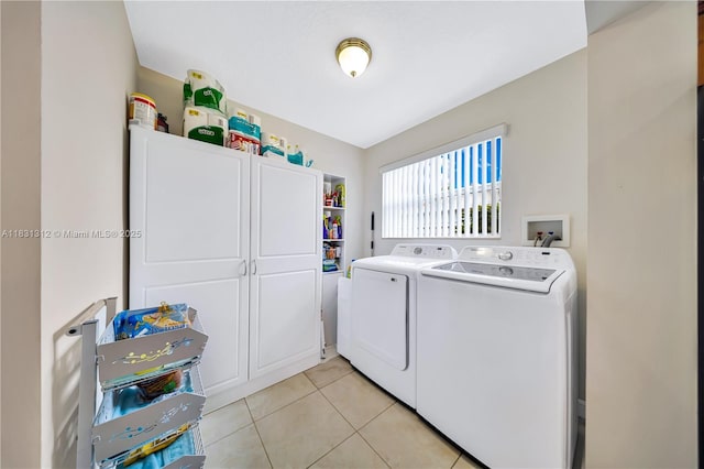 1315 W 79th St, Hialeah, FL 33014 - laundry area with washing machine and dryer, cabinet space, and light tile patterned floors
