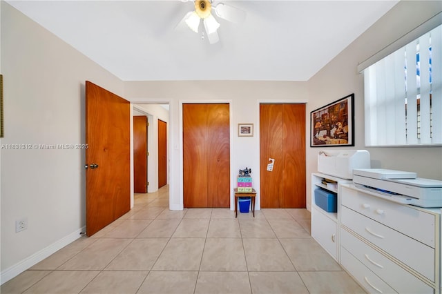 1315 W 79th St, Hialeah, FL 33014 - bedroom featuring two closets, light tile patterned flooring, and a ceiling fan