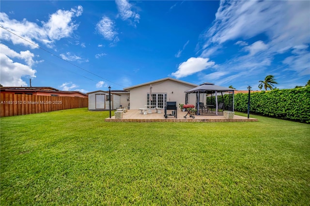1315 W 79th St, Hialeah, FL 33014 - back of house featuring a gazebo, a patio area, a shed, a fenced backyard, and stucco siding
