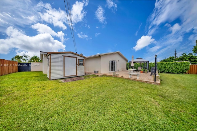 1315 W 79th St, Hialeah, FL 33014 - back of property with a gazebo, a patio, a storage unit, a fenced backyard, and stucco siding