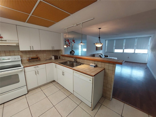 1351 NE Miami Gardens Dr Unit 513E, Miami, FL 33179 - kitchen with white appliances, under cabinet range hood, track lighting, a peninsula, and tile countertops