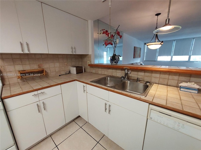 1351 NE Miami Gardens Dr Unit 513E, Miami, FL 33179 - kitchen with dishwasher, white cabinets, backsplash, tile countertops, and light tile patterned floors