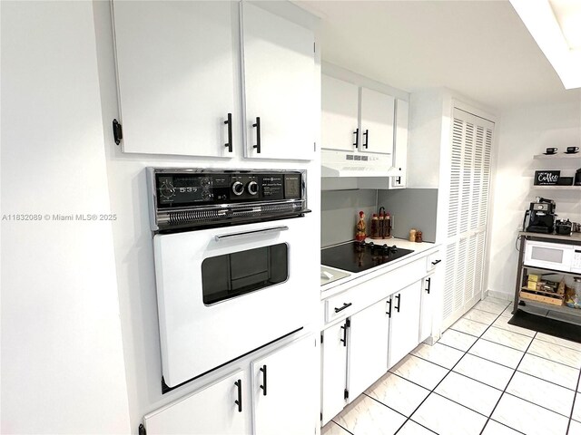8821 SW 87th St, Miami, FL 33173 - kitchen featuring white appliances, under cabinet range hood, white cabinets, and light countertops